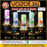 Six Vozol Salt Prime e-liquid 20 Mg & 50 Mg bottles in different flavors (Grape Ice, Blueberry Ice, Watermelon Ice, Mint Ice, and Tropical Mango) displayed on black pedestals against a dark background with glowing effects. The image features a gold banner at the top, a red circular 'Vape Buy Me' badge on the left, and informational text and icons at the bottom.